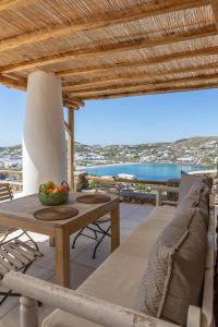 a patio with a table and chairs and a view of the ocean at Casa Elena in Aggelika