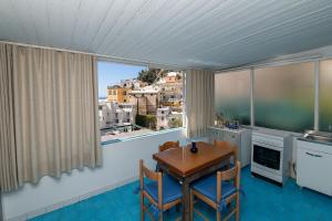 a kitchen with a table and chairs and a window at Casa Maresca Residence in Positano