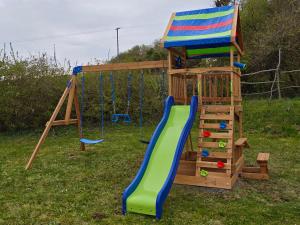 a playground with a slide and a playset at Bon Villa in Zalaszentgrót