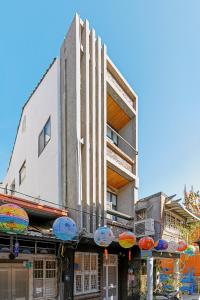 a building with colorful umbrellas in front of it at 傅棧 Fu Yu in Tainan +153 photos