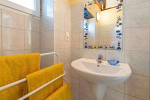 a bathroom with a sink and a mirror at Maisonnette Chez Aurèle in Santa-Maria-di-Lota +12 photos