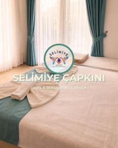 a logo of a bed in a room at Selimiye Çapkını in Marmaris
