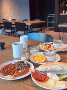 a wooden table with plates of food on it at Penzion Kouty in Loučná nad Desnou