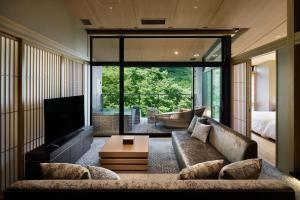a living room with a couch and a television at Hatsuhana in Hakone
