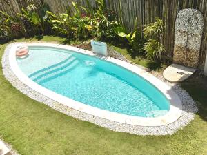 a swimming pool in a yard with a laptop in it at Laya Boutique Hotel in General Luna