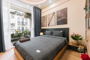 a bedroom with a large bed and a window at Supper Location City view 3Br 5CG in Hanoi