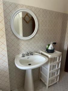 a bathroom with a sink and a mirror at Casa COMER GRISOLIA in Cirella +7 photos