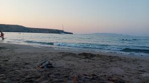 a pile of rocks on a beach with the ocean at Casa Nefeli in Karteros +68 photos