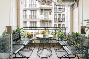 a balcony with a table and benches and a building at Supper Location City view 3Br 5CG in Hanoi