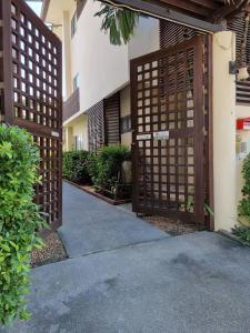 an entrance to a building with a wooden gate at Apartment Eliza Samui in Garden Resort with Shared Pool in Plai Laem