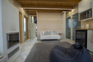 a living room with a white couch and a fireplace at Rantarovio in Alvajärvi