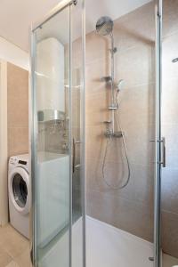 a shower with a glass door in a bathroom at Apartment Lassy by Irundo in Rovinj +3 photos