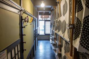 a hallway of a room with a bunch of wine bottles at Hostel Nakamura Kobe in Kobe