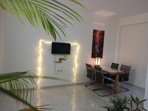 a room with a desk and a television and lights at O2 Homes in Guwahati
