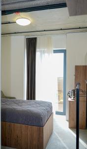 a bedroom with a bed and a large window at Chechakar Boutique Hotel in Ditavan