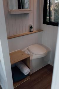 a small bathroom with a toilet and a window at Tiny Tamborine 1 by Tiny Away in Wongawallan +16 photos