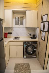 a small kitchen with a washing machine in it at أجنحة لوسيل 3 Lucille Suites in Jeddah