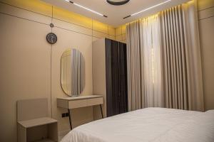 a bedroom with a white bed and a mirror at أجنحة لوسيل 3 Lucille Suites in Jeddah +26 photos