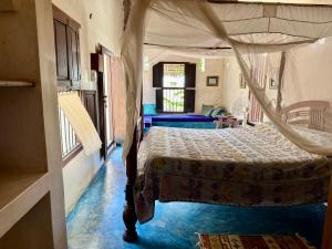 a bedroom with a bed with a canopy at Subira House in Lamu