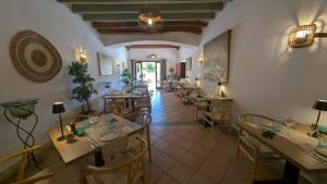 a restaurant with tables and chairs in a room at Boutique Hotel Sa Galera in Caʼs Concos