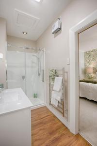a bathroom with a shower and a sink at The Terrace - Luxury Villa in the heart of Oamaru in Oamaru +44 photos