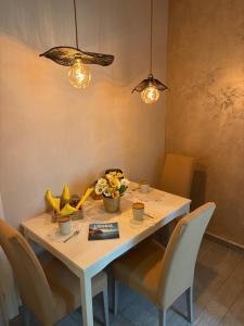 a white table with chairs and fruit on it at Affittacamere La Risacca in La Spezia