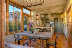 a kitchen and dining room with a table and chairs at The Terrace - Luxury Villa in the heart of Oamaru in Oamaru