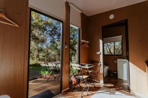 a room with a patio with a table and chairs at Wildlife Haven by Tiny Away in Agnes Water