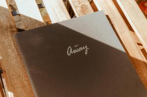 a laptop sitting on top of a wooden chair at Wildlife Haven by Tiny Away in Agnes Water +31 photos