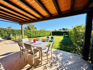 a white table and chairs on a patio at Villa Giovanna - Residence with Pool in Campofelice di Roccella