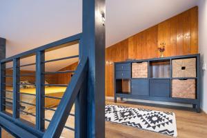 a room with a bunk bed and a staircase at White Lotus Mini Loft House in Mezőkövesd