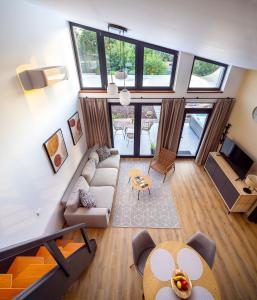 a living room with a couch and a table at White Lotus Mini Loft House in Mezőkövesd