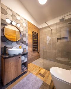 a bathroom with a sink and a shower at White Lotus Mini Loft House in Mezőkövesd +22 photos