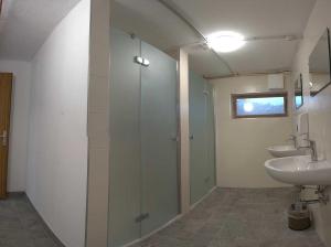 a bathroom with two sinks and a shower and a mirror at Galtalm in Fulpmes
