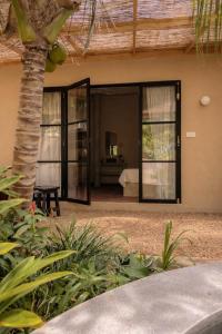 a view of a bedroom from the outside of a house at Design Cabin with Plunge Pool in Ahangama
