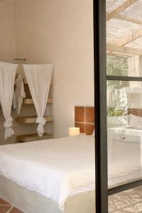 a bedroom with a white bed and a window at Design Cabin with Plunge Pool in Ahangama