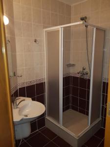 a bathroom with a shower and a sink and a toilet at Malhun Hotel in Fethiye