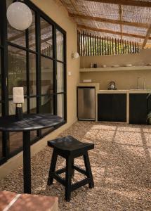 a living room with a table and a kitchen at Design Cabin with Plunge Pool in Ahangama +15 photos