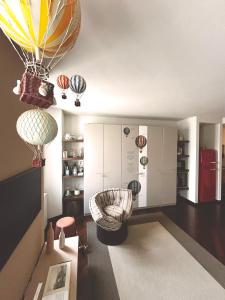 a room with a room with hot air balloons on the ceiling at COMO mi CASA in Malgrate +27 photos