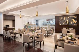 a restaurant with tables and chairs and a bar at Address Dubai Mall in Dubai