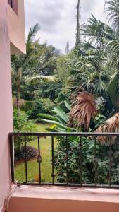 a balcony with a view of a garden at rossylyn lonetree two bed bedroom in Nairobi
