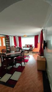 a living room with a table and a couch at rossylyn lonetree two bed bedroom in Nairobi +8 photos