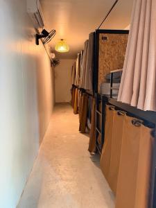 a room with a long hallway with curtains and a room with at Malila Sea Breeze Hostel in Ko Tao
