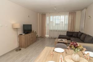 a living room with a couch and a table at Active Homes in Veliko Tŭrnovo