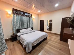 a bedroom with a bed and a window at Valley Roots Homestay in Ziro