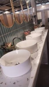 a row of white toilets on a counter in a bathroom at Malila Sea Breeze Hostel in Ko Tao +24 photos