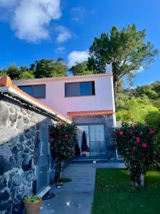 a villa with a view of the house at Casa da Petra in Urzelina