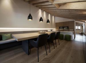 a dining room with a wooden table and chairs at Edelweiss Apartments in Lech am Arlberg