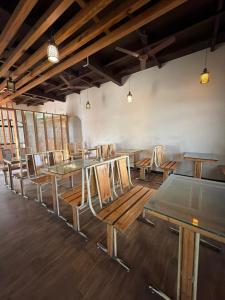 a row of tables and chairs in a room at O'Nest Select in Peth