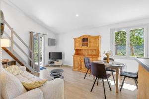 a living room with a table and a couch at Location Gîte Les Iris in La Robine